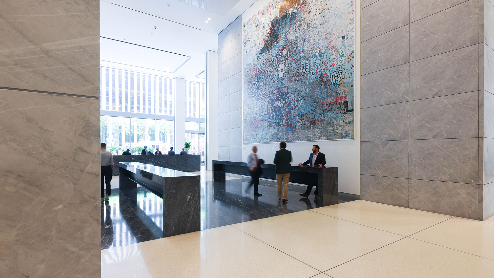 Lobby view of 1221 Avenue of America with large blue marble reception desk